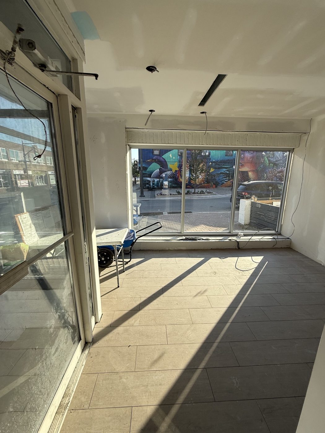 Finished flooring and front windows looking out onto Dunlop Street West